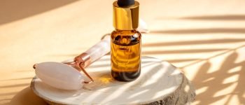 beauty products: facial roller, cosmetic oil and serum